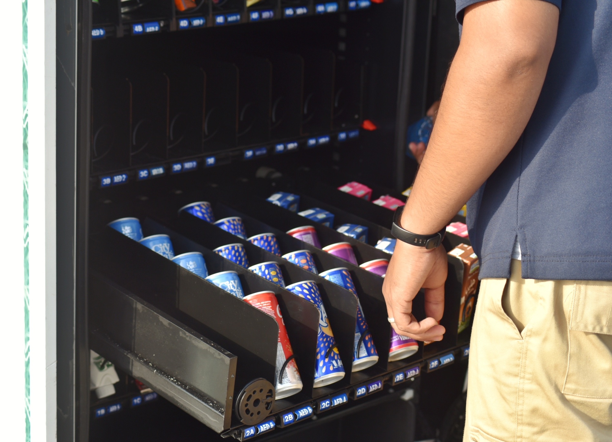 Local Snack Vending Machine Being Stocked by Supplier.